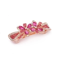 Detailed macro of rose gold bow hair clip with pink rhinestones and flower crystals - Style B / Pink