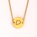 Macro view of gold stainless steel coin pendant with镂空 letter D on an O-shaped chain - Letter D