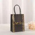 Detail of black paper gift bag with gold foil border and Arabic calligraphy handle - 21x15x8cm / Black Style B