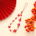 Detail of red and white beaded phone strap with star and butterfly charms on beige base - K2890 Chinese Style Star Phone Chain