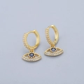Close-up of golden evil eye hoop earring with blue stone and pavé zircon details - Evil Eye Earrings - Gold