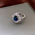 Close-up of silver ring with blue oval stone surrounded by marquise-cut zircons - Blue Water Drop Flower Cluster Style (WR431) / Silver Band / Blue Main Stone