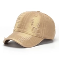 Detailed close-up of distressed denim baseball cap with vintage worn-out holes and frayed edges - Khaki