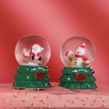 Close-up of Christmas crystal ball with Santa and Snowman on green tree bases - No. 80 Glowing Music Christmas Tree Snow Globe Random Style