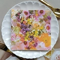 Floral printed paper napkin with colorful pansy and rose patterns on a white plate - Pansy Rose Hydrangea (1117)
