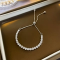 Close-up of adjustable silver tennis bracelet with clear round-cut zircons on a leather tray - Silver (2#)
