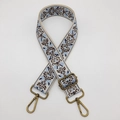 Close-up of wide embroidered bag strap in blue and brown with antique bronze metal buckles - Beige Light Blue Bronze Hook