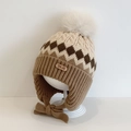 Knitted earflap hat for kids in beige and brown with a large fluffy pom-pom - Rhombus Twist / Beige Khaki