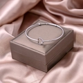 Polished silver heart knot open bangle displayed on a luxury jewelry gift box - Heart Style (S276-2)