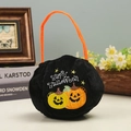 Embroidered black velvet Halloween pumpkin candy bag with orange handle and festive text - Double Pumpkins