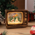 Detail of vintage TV Christmas snow globe with Santa sleigh and festive scenery - Gold TV House