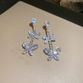 Detailed view of silver zircon butterfly tassel earrings on a premium beige background - Silver Butterfly Silver Pin Earrings (161#)