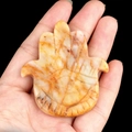 Hamsa Hand figurine carved from natural yellow and orange veined crystal stone - Topaz