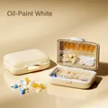 Portable double-layer pill box organizer in cream white with secure metal latch - Creamy White