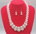 Macro detail of multi-layer pearl necklace with rhinestone accents on a red stand - Elegant Pearl Rhinestone Jewelry Set Elegant Style
