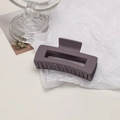 Detail of large matte purple hollow hair claw clip with frosted texture on textured background - Cube / Purple
