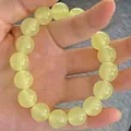 Elegant beaded bracelet with polished light green round gemstone beads on hand - S070-12mm Bracelet [icy Yellow] Glass Material #sz556