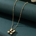 Detailed macro view of the 3D puffed letter H gold pendant and delicate bead chain - Letter H