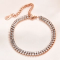 Macro view of 6mm double-row rhinestone rose gold bracelet with lobster clasp and chain - Rose Gold