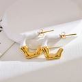 Detail of irregular C-shaped gold-plated stainless steel earrings with white enamel finish - White