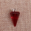 Macro shot of faceted red crystal pendulum pendant on rustic burlap background texture - Transparent Red