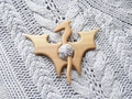 Macro shot of bat-shaped wooden brooch pin on gray knitted sweater texture detail - Dragon