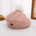 Detail of pink knitted beret featuring a soft white faux fur pom-pom and bow embroidery - 2-4 years old / Pink