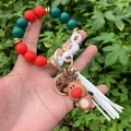 Detail of Christmas beaded bracelet with reindeer charm and white leather tassel - Style 10 (Brown Reindeer Figure)