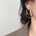 Detail of elegant contrasting gold and silver oval earrings worn on model's ear - 18# Silver Earring Post - Silver - Color Block