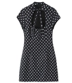 Detail of black polka dot mini dress with high tie-neck bow and teardrop cutout design - XS / Black Polka Dot