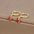 Macro shot of strawberry earrings with red heart stones and green leaves in gold finish - Gold Apple