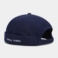 Detail of dark blue brimless docker hat featuring white Chill Vibes letter embroidery - Adjustable / Navy Blue