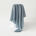 Detail of blue pleated square scarf draped over a white cube showing fabric texture - Light Blue