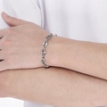 Detailed view of a silver stainless steel anchor link bracelet worn on a wrist - Anchor Chain Style / Steel Color (KB188484-Z)