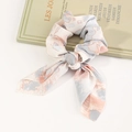 Tie-dye ribbon bow scrunchie with pink and grey marble print on a silk fabric texture - Blue