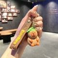 Cute Capybara keychain featuring a green leaf hat, brown wrist strap, and golden clip - B207-3 Green Leaf Hat