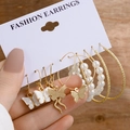 Detail view of 6-piece gold earring set with white butterfly charms and pearls on display - Butterfly Pendant Pearl Set (Z11)