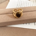 Close-up of 18k gold plated tiger eye ring with twist band on a velvet stand - Oval Large Stone Style (2#戒指-咖色(真金电镀)