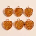 Détail de pendentifs en forme de cœur orange avec paillettes dorées pour création de bijoux - Orange