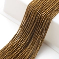 Detailed view of faceted glass beads in antique gold finish for DIY jewelry crafting - Gold Plating