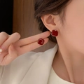 Macro detail of red geometric stud earrings with gold trim and glossy resin finish - Deep Red Square Retro Style (A02)