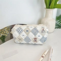 Detail of quilted cosmetic bag featuring bear patterns and a smooth top zipper closure - Diamond Bear