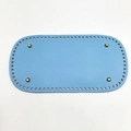Detail of sky blue oval PU leather bag bottom with pre-punched holes and metal studs - Blue