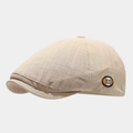 Detail of beige newsboy cap featuring cross-check texture and circular M logo patch - Adjustable / Beige