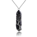 Macro view of handmade wire wrapped tree of life pendant on black crystal pillar - Wire Wrapped Black Agate + Metal Chain
