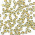 Flat lay of translucent light cyan acrylic alphabet beads with gold glitter letters - New Transparent Gold Letters