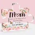 Macro shot of puzzle-shaped acrylic plaque with pink roses and Mom tribute text - Mom Pink Classic Style (Q17)