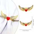 Golden alloy napkin ring featuring a red heart with sparkling rhinestone wings - Wings Surround Red Heart Rhinestone