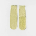Non-slip yoga socks in light green with ruffled cuffs and silicone grips on white background - One Size / Light Green