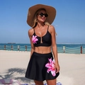 Detail of black two-piece bikini featuring pink lily floral print and high-waist swim skirt - S / Black Pink Floral